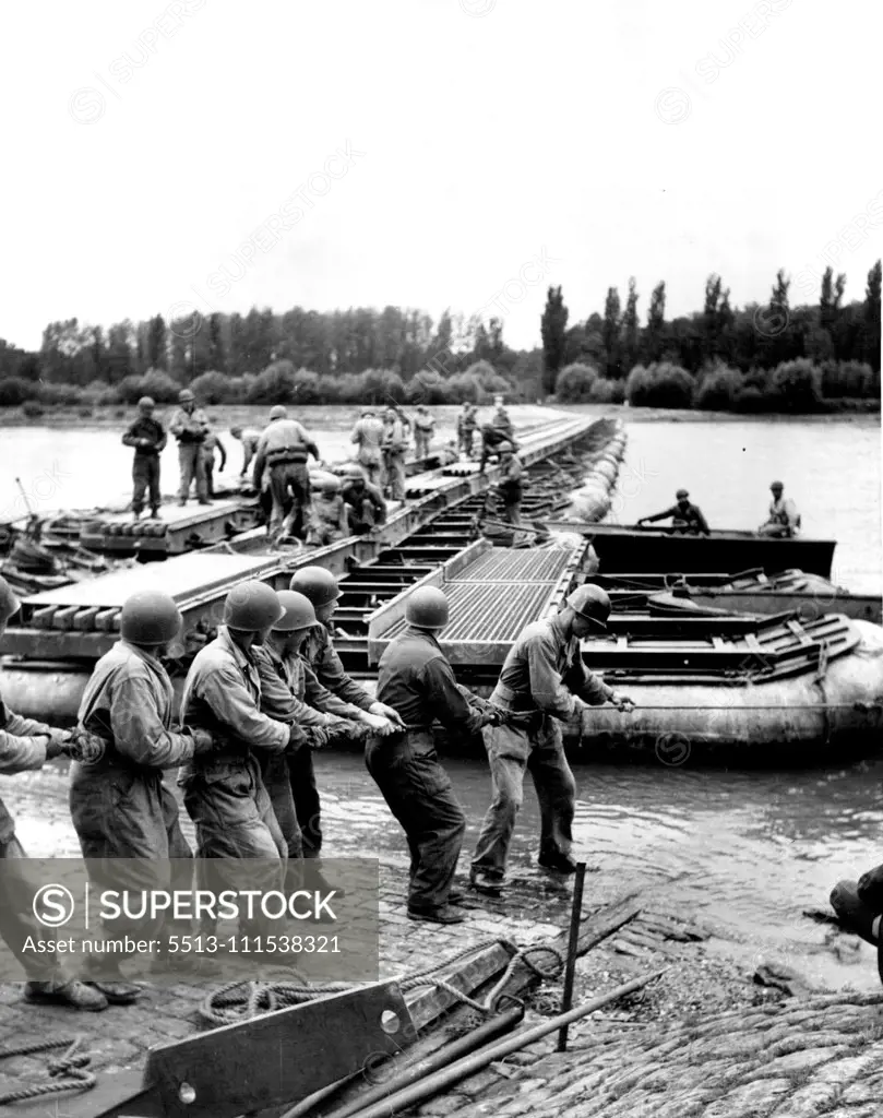 German G.I.'s (Third of Six) - Officers and men of an engineer bridge maintenance company tackle a repair job on a temporary bridge spanning the Rhine river. November 3, 1950. (Photo by ACME).
