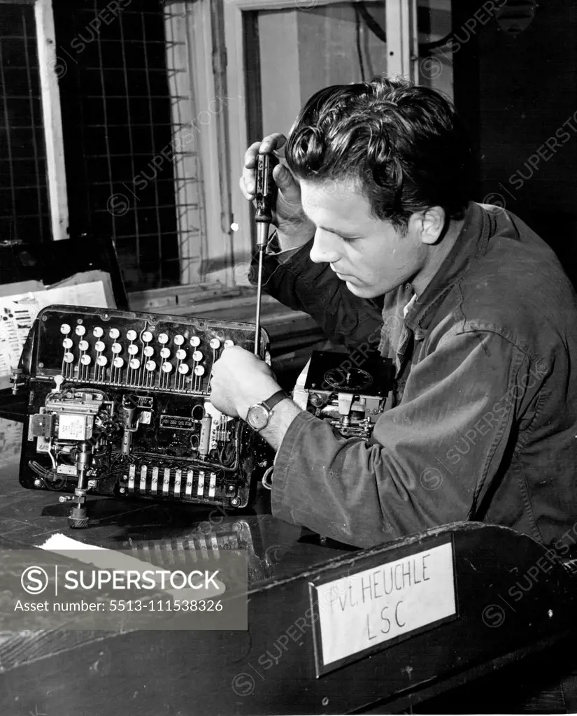 German G.I.'s (Sixth - End of Set) - Repair and maintenance work is one of many necessary duties assigned to labor service unit workers. Private Heuchle, a young German civilian, repairs a teletype machine at a U.S. Signal Depot in Germany. November 3, 1950. (Photo by ACME).