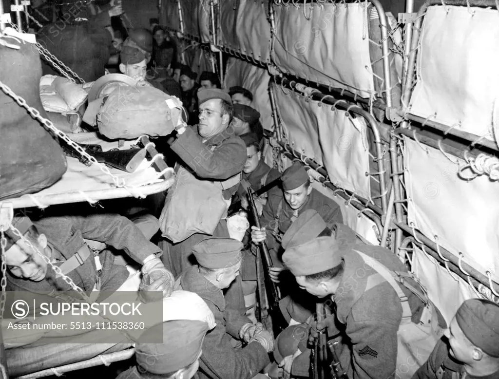 Yanks Prepare to Land: Fully dressed, duffle-bags packed and rifles ready, American soldiers on a troopship that arrived recently at a Northern Ireland port await the signal to disembark. Washington announced arrival of the big A.E.F. May 18. May 27, 1942. (Photo by Associated Press Photo).