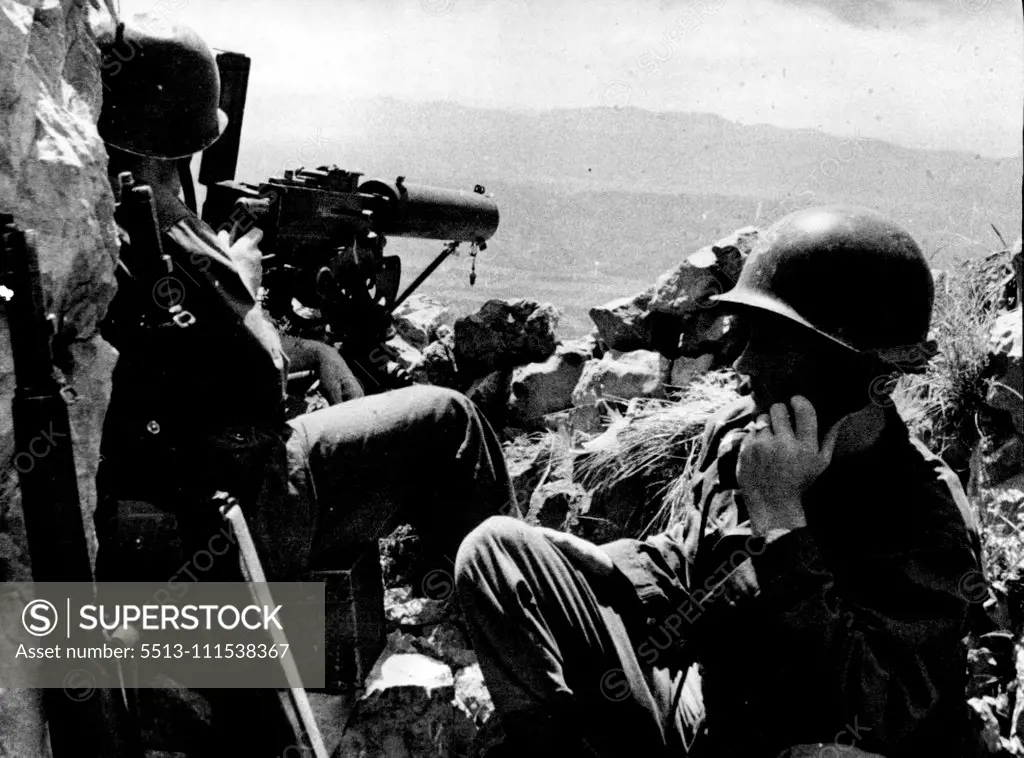 On Guard in Trieste Area: American soldiers stand guard with a mounted machine gun at an observation post in the mountains near Trieste. The port is still paralyzed by a general strike which has been declared illegal by allied military authorities. June 7, 1946. (Photo by Associated Press-Paramount News Photo).