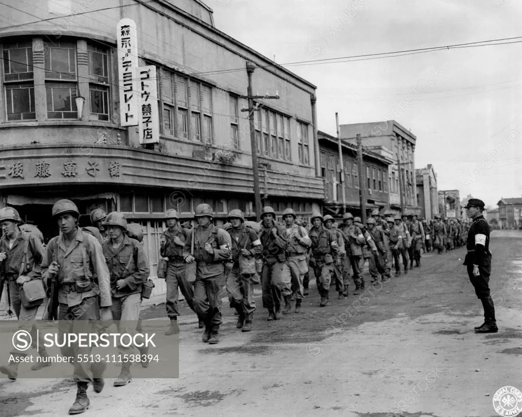 Occupation troops, of the 81st Infantry Division, march into Hirosaki, nead Aomori, Japan, with a Japanese policeman to guide them into the city. Scenes such as this, are typical as the American Forces' take up their zones of occupation. February 25, 1946. (Photo by US Signal Corps Photo).