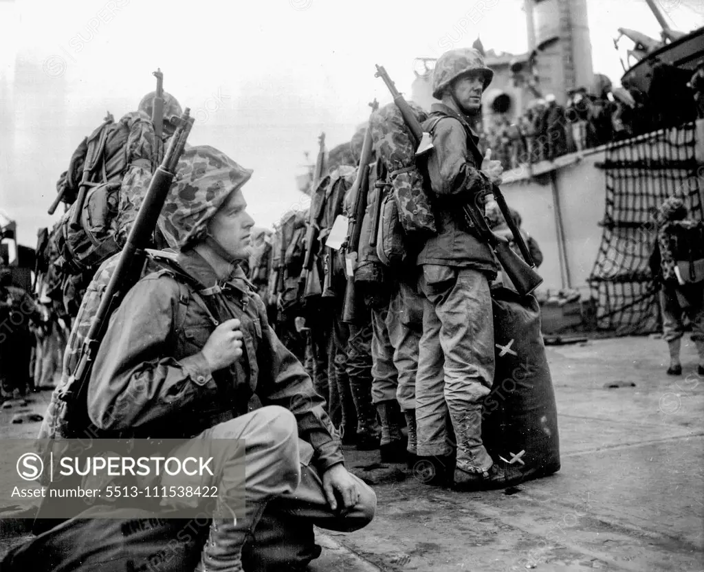 To the Hot War (first of five) - Waitin' for their ship to come in - but this ship carries no dreams of soft and splendid living for the battle-bound marines. Pfc Philip Kreebs of Abilene, Texas, squats on his barracks bag as his buddies stand at east on the pier. November 16, 1951. (Photo by ACME).