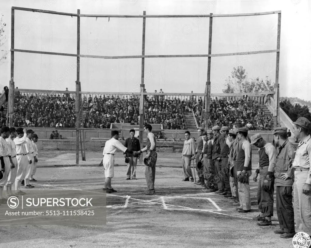 Baseball in Korea: At Souel, Korea, the old American game of baseball, banned by the Japanese for 6 years, was revived when a team of American occupation signalmen met a team from the Korean Amateur Association. The Koreans won, 4-3, before a crowd of ten thousand soldiers and civilians. October 25, 1945. (Photo by Davis, US Army Signal Corps Photo).