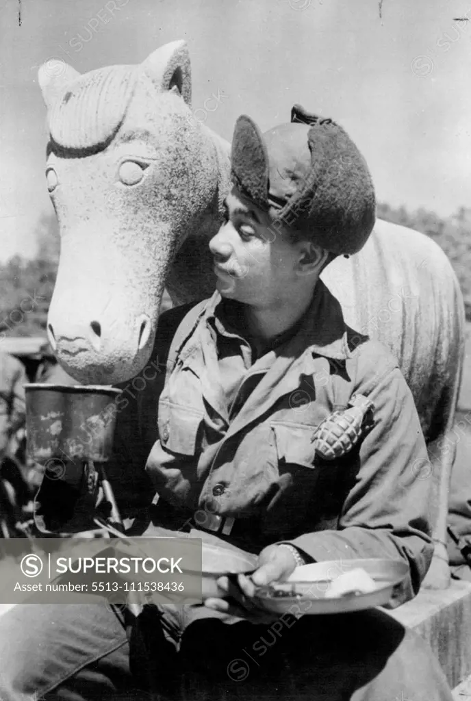Stony Refusal in Korea: Gentle humour from the grim war scene of Korea is carried by this picture of American infantryman Private (Pirut Class) William E. Kellogg, who offers his coffee to a stone horse standing guard at Kamgong-Ni Temple, 12 miles east of Seoul. The horse maintained a ***** a style favoured by many modern sculptors - le eloquent enough to students of art. April 6, 1951. (Photo by Reuterphoto).