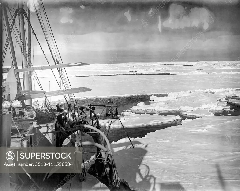 Pushing Aside great ice floes the Discovery II. made her way into the southern wilderness to rescue the missing American explorers. The two figures on the platform with the pole are trying to keep the ship clear of floes. Note the search plane. January 1, 1950.