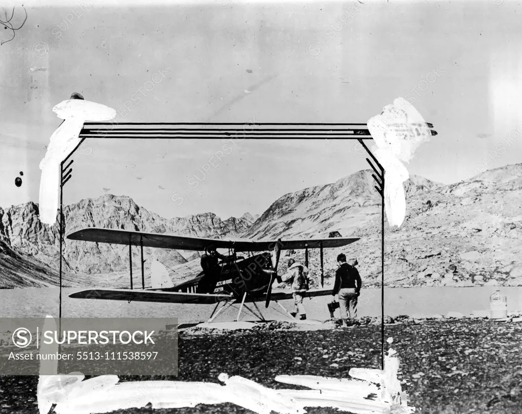 British Arctic Air Route Expedition: The seaplane on a lake which was used as flying base for a week during the Northern Coast Survey. Flt. Lt. D'Aeth, H. G. Watkins (leader of the expedition) and W. E. Hampton can be seen with the plane. October 25, 1930. (Photo by British Arctic Air Route Expedition Photograph).