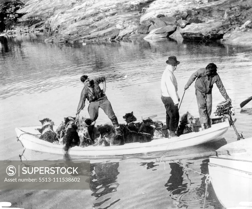 British Arctic Air Route Expedition: Ferrying dogs across the Fjord for the beginning of the journey. Left to right - Scott, Hampton and Courtauld. September 15, 1931. (Photo by British Arctic Air Route Expedition Photograph).