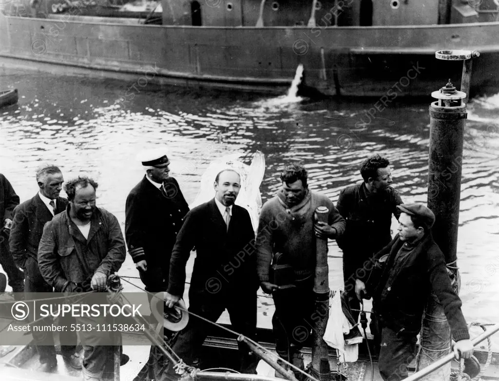 'The Nautilus Arrives in Ireland': Sir Hubert Wilkins with members of his crew aboard showing the broken periscope and hand rail. The Nautilus in which Sir Hubert Wilkins hopes to reach the North Pole, arrived at Queenstown, Ireland yesterday. June 23, 1931. (Photo by Photopress).
