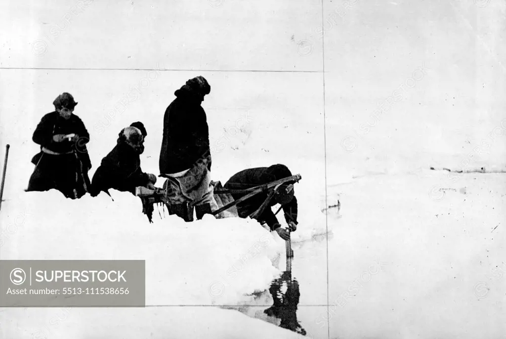 Scientifical work on the Soviet North Pole Station: The winter dwellers of the Soviet station on the drifting ice-floe, taking the first water test from the Arctic Ocean on the North Pole. July 1, 1937. (Photo by Soyuzphoto).