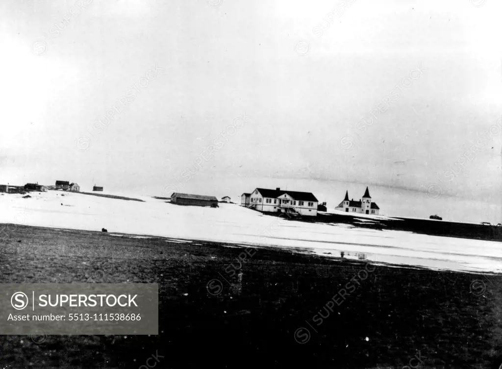 First Pictures on Nielson Search: Land's End - This photo gives graphic idea of the bleakness of point barrow, Alaska, district, from which search for pilot Eielson and Mechanician Borland is conducted. In the background is the Presbyterian mission hospital and church at point barrow, farthermost point of land in Alaska. February 5, 1930. (Photo by International Newsreel Photo).
