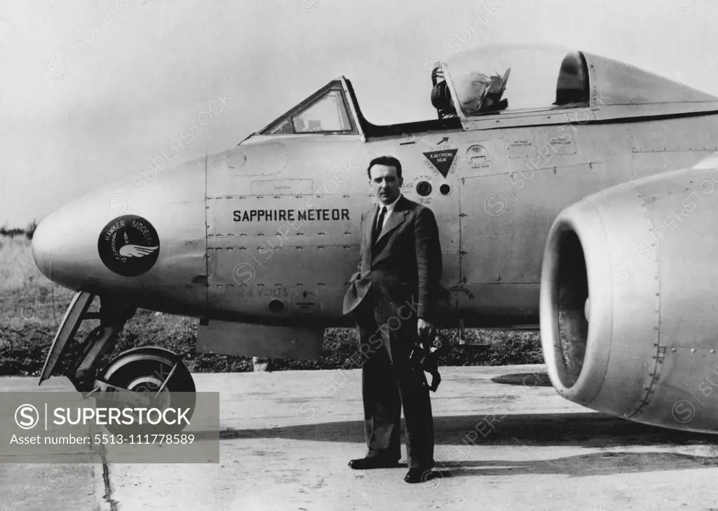 Collected Climbing Records. Wearing an ordinary lounge suit and regulation flying helmet, Flight- Lieutenant R.B. ("Tom") Prickett, 29-year-old test pilot is pictured before stepping into the plane behind him - the Hawker Siddeley Sapphire Meteor twin jet aircraft in which he collected four world records for Britain. Flying from the aerodrome here the aircraft climbed to 39,600 feet, or nearly seven and & half miles, in three minutes seven seconds. Other records scooped up by the Meteor were 9,8