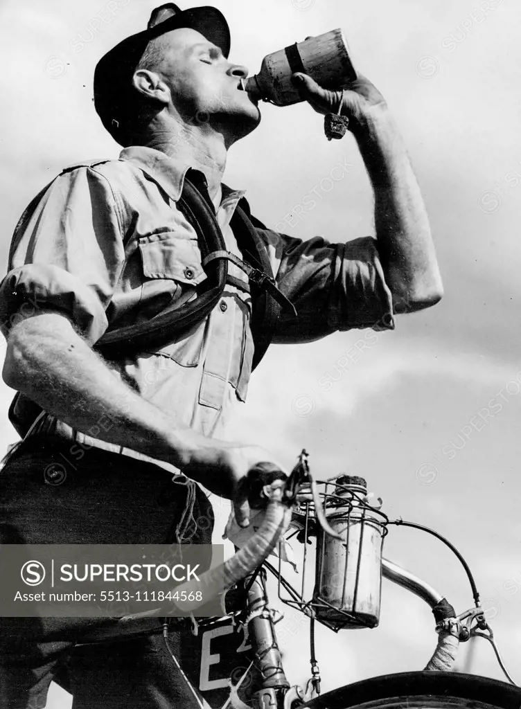 Laurie Sullwan takes a drink from Bidon at Gosford. December 15, 1949.;Laurie Sullwan takes a drink from Bidon at Gosford.