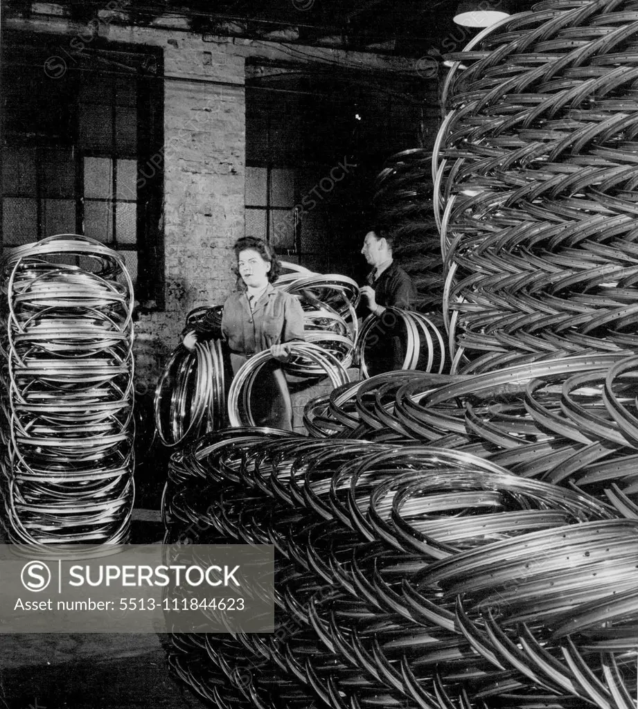 British Bicycles For The World - Up to 50,000 wheel rims can be held in this rim store. Rims of all sizes are stacked by expert workmen to avoid any distortion. July 09, 1951.;British Bicycles For The World - Up to 50,000 wheel rims can be held in this rim store. Rims of all sizes are stacked by expert workmen to avoid any distortion.