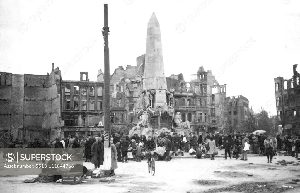 Germans Sell Out To Poles In Danzig -- The crowded scene in a market square in Danzig as the Germans dispose of chattels to the poles. The Germans dispose of chattels to the poles. Building smashed by German attacks and allied bombings are seen in back ground. Germans, former residents in Danzig, now ordered to evacuate. To the rich, are selling most of their belongings to the poles - now masters of the Baltic port - before leaving for the Fatherland. October 18, 1945. (Photo by Associated Pres