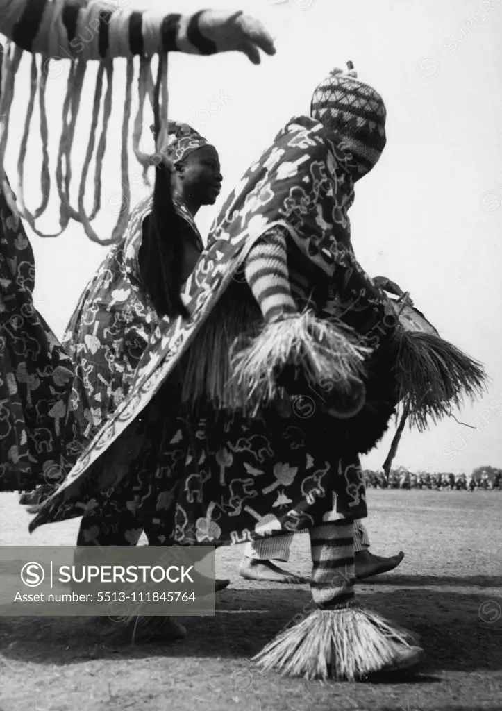 His head completely covered and clad in a colorful dress trimmed with straw this ian tribesman was among the 7,000 who paraded before the Queen at the Kaduna rally on Thursday (2-2-56). February 17, 1955. (Photo by Daily Mirror).;His head completely covered and clad in a colorful dress trimmed with straw this ian tribesman was among the 7,000 who paraded before the Queen at the Kaduna rally on Thursday (2-2-56).