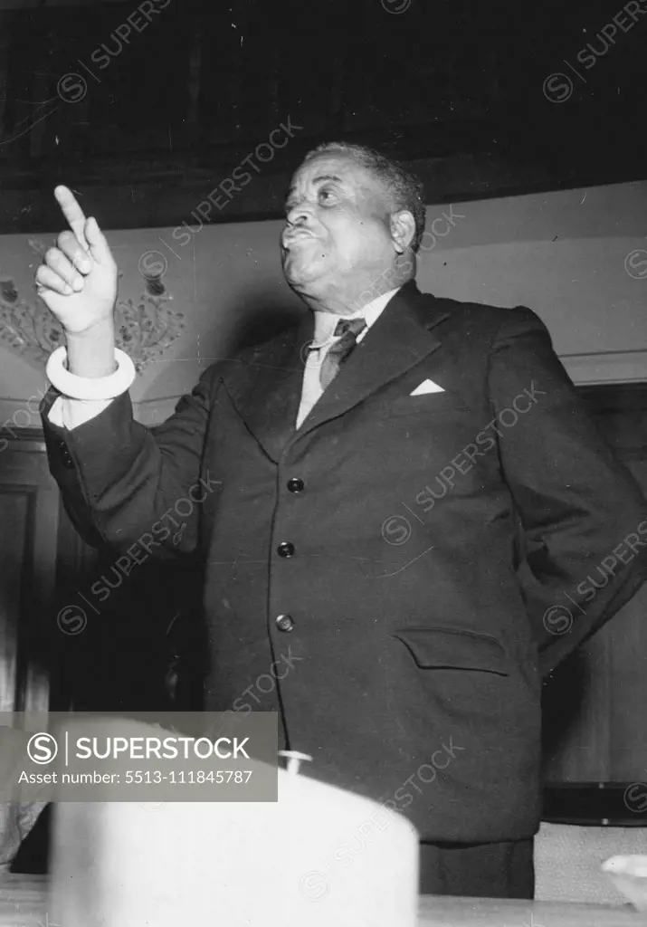 Africa Appeals To London -- Paramount Chief M'Uberna who said that if Atom bombs were dropped they would still not yield to Federation, seen wearing they only tribal sign, in a western suit, an ivory bracelet. January 24, 1953. (Photo by Daily Mail Contract Picture).;Africa Appeals To London -- Paramount Chief M'Uberna who said that if Atom bombs were dropped they would still not yield to Federation, seen wearing they only tribal sign, in a western suit, an ivory bracelet.