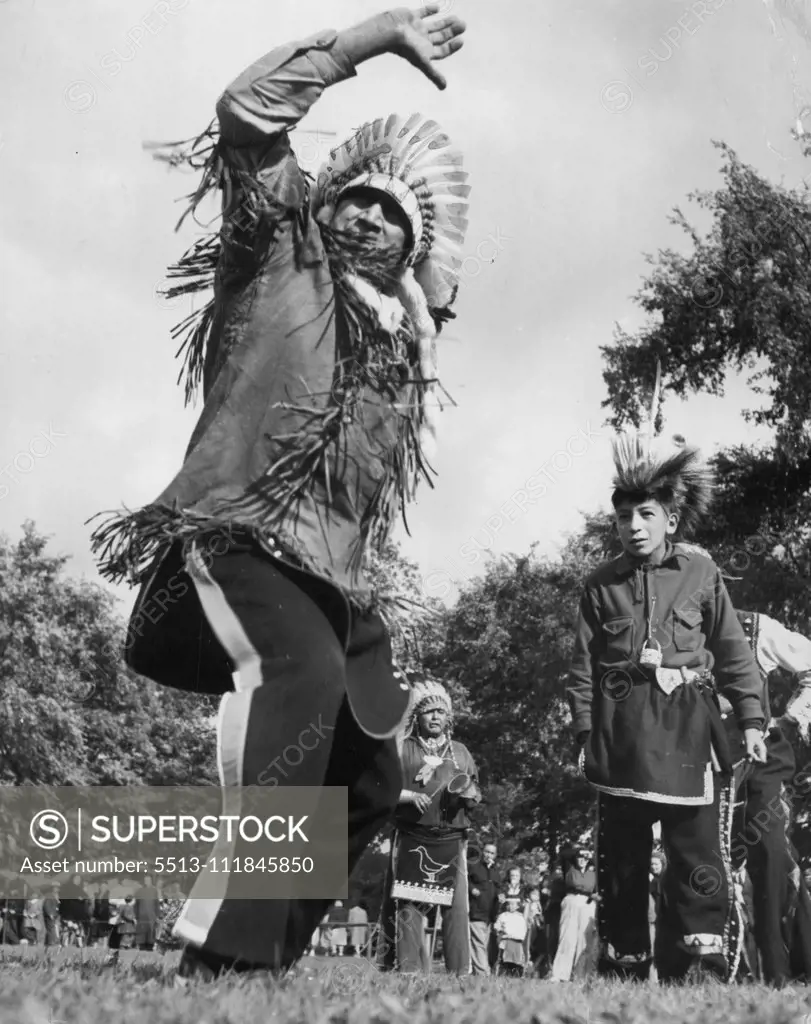 Hi, Ho, Come To The Fair (Eleventh Of Fifteen) -- War dances by New York Indian tribesmen were a popular event every morning. Young "Warrior" (at right) seems fascinated by the gyrations of an older tribesman. September 23, 1949. (Photo by ACME).;Hi, Ho, Come To The Fair (Eleventh Of Fifteen) -- War dances by New York Indian tribesmen were a popular event every morning. Young "Warrior" (at right) seems fascinated by the gyrations of an older tribesman.