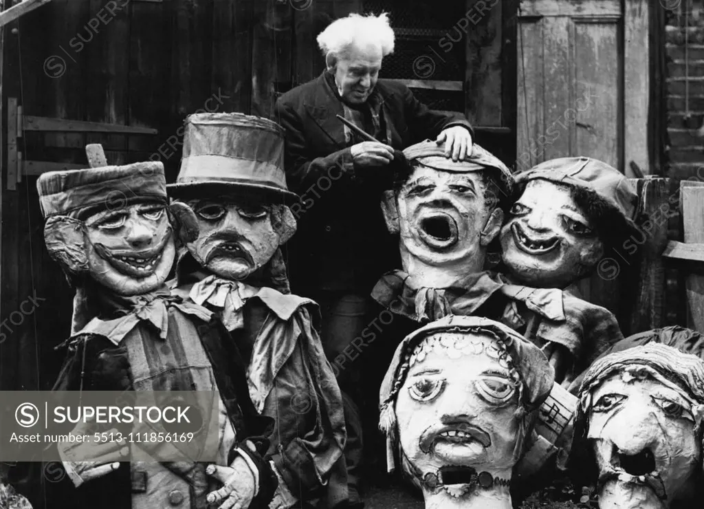 81-Year-old Barnum And Bailey Clown Still Makes Them Laugh -- 81-year-old Harry Russell photographed at work among some of his grotesque giant heads which he makes. In a white-washed shed in Norwood High Street, West Norwood, a youthful old man with a bushy mop of white hair continues a long life of making people laugh. 81-year-old Mr. Harry Russell was once a famous clown with Barnum and Bailey's circus, an claims to be its oldest survivor. He now spends his days making the giant papier mache 