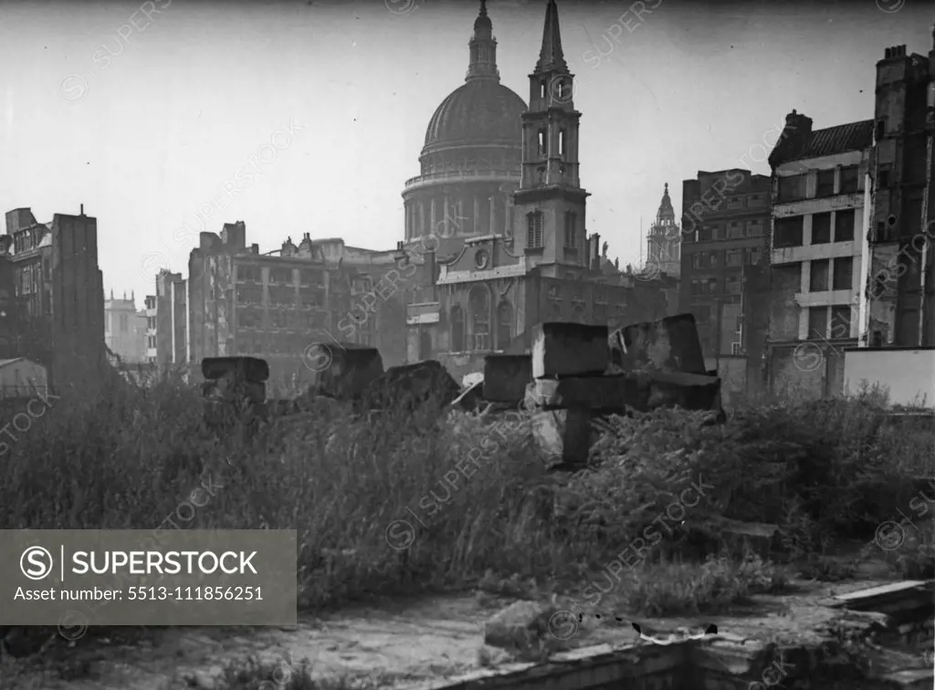 A Wilderness in The Heart of The City of London - Great boulders lie among long grass and weeds where once tail building stood. A church, bombed in 1940, is just a shell. It is the Parich church of St. Vedast, built before 1249, and rebuilt by Sir. Christopher Wren in 1666. The scene - looking towards St. Paul's from Wood Street, is typical of many parts of our great City to-day, the bomb-scarred city for which the new Lord Mayor of London appealed in his Guildhall speech last night. "Let this r