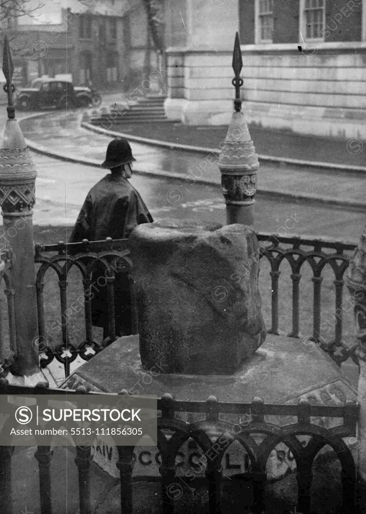 He Guards Another Coronation Stone - A police constable here needs watch over the Saxon Coronation Stone (in foreground) at Kingston-on-Thames (near London). The policeman was put on guard after the scone coronation stone was stolen from Westminster Abbey on Christmas Day. Scottish nationalists threatened last March to remove the Saxon Coronation Stone and hold it as ransom against the return of the Abbey Stone, which, police believe, they have now stolen. December 28, 1950. (Photo by Associated