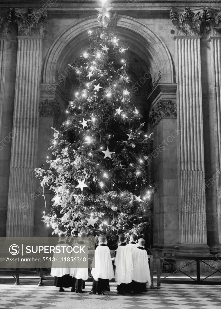 A Royal Look For A Royal Tree Boys from the St. Paul's Cathedral Choir School seen admiring the Christmas tree on the Cathedral steps as they illuminations are tested this morning. The work of decorating, and illuminating the two 36ft. Royal Christmas trees at St. Paul's Cathedral is being completed today and from tomorrow, the trees will be illuminated each day and evening until January 6th. It Is an annual custom to erect two tress at St. Paul's, one on the stops of the Cathedral and on-9 insi