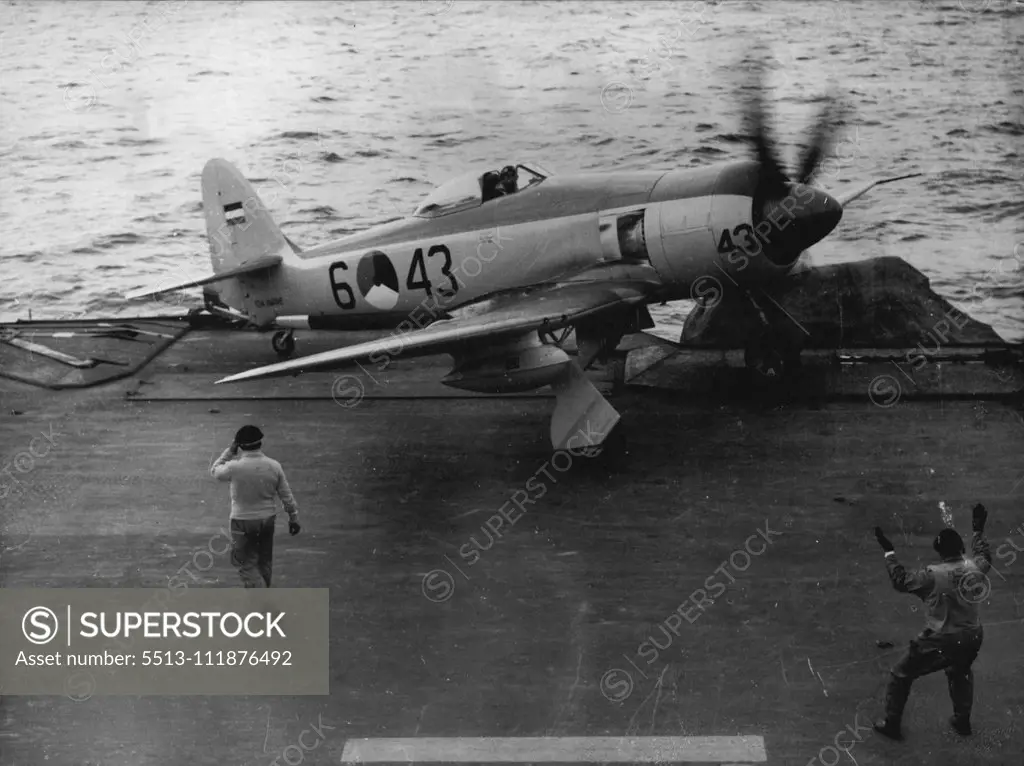 Near Thing -- A Dutch Royal Air Force Hawker Sea Fury plane nearly goes over the side of the flight deck of the British Aircraft carrier, H.M.S. Illustrious, after a patrol in the north Atlantic during the giant NATO "operation mainbrace." The flight deck officer (right) coaxes the pilot away from the edge. Over 150 warships are taking part in the operation designed to test the defence of Northern Europe. September 21, 1952. (Photo by Associated Press Photo). ;Near Thing -- A Dutch Royal Air F