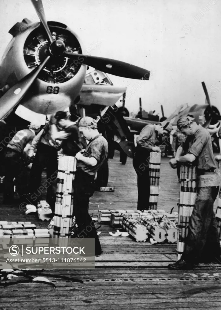 U.S. Bombers ***** For Raid On Tarawa -- Sailors on an American aircraft carrier load incendiary bombs aboard U.S. Navy planes during a raid on Tarawa, Japanese base in the Gilbert Islands. The picture was taken between bombing missions. Planes from the carrier made repeated attacks on the enemy based during a two-day period, silencing many Japanese anti-aircraft batteries and destroying other installations. Long-range Army and Navy bombers also took part. November 29, 1943. (Photo by U.S. Offi