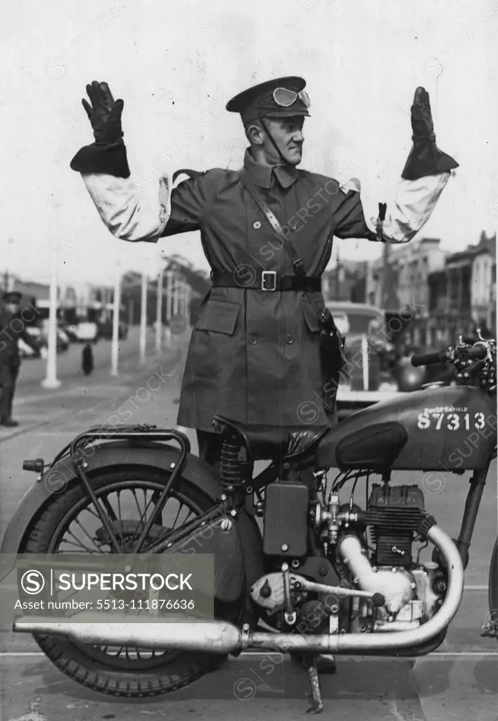 The Army Takes Control -- On duty in Victoria Street today this member of the Australian Provost Corps dismounted from his motor cycle to direct military transports. August 24, 1942.;The Army Takes Control -- On duty in Victoria Street today this member of the Australian Provost Corps dismounted from his motor cycle to direct military transports.