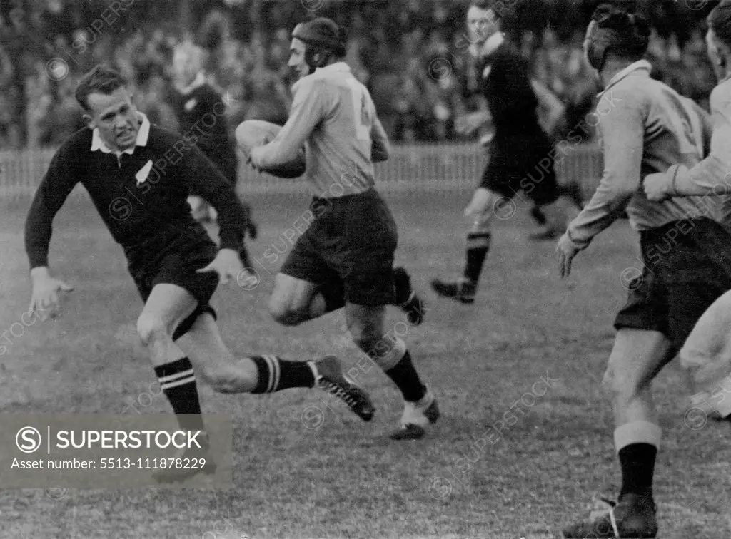Dashing NSW centre, Trevor Allan, playing his first game against the All Blacks, cuts inside a defender at the Cricket Ground yesterday. June 22, 1947.