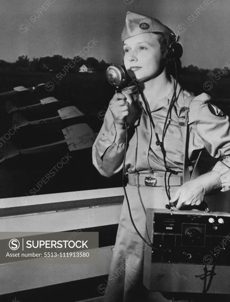 U.S. Women Now Sentinels Of The Air -- Mrs. Henry H. Hubbard, an adjutant with the squadron, talks with a plane flying above the airport. Members who do not hold flying licenses comprise a corps of observers and radio operators on the ground and in the air. July 21, 1943.