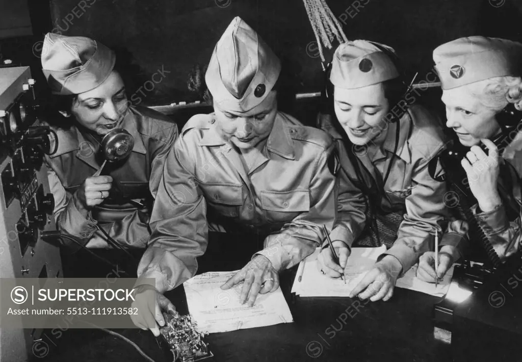 U.S. Woman Now Sentinels Of The Air -- Four members of the Civilian Air Patrol squadron study the Morse code for radio messages. November 2, 1942. (Photo by Interphoto News Pictures, Inc.).