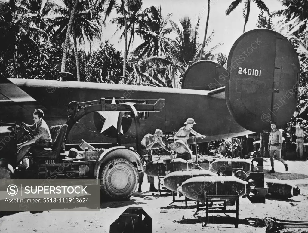 U.S. Raid On Japanese Bases In Gilbert Islands -- U.S. Amy Force crews load a heavy bombing plane at Funafuti, new American air base in the Ellice Islands of the South Pacific, in preparation for an attack on a Japanese base in the Pacific. July 21, 1943. (Photo by U.S. Office Of War Information Picture).