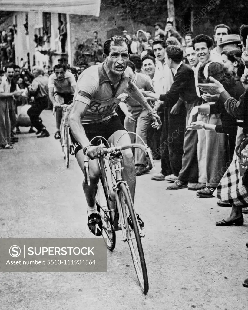 The Man who Stopped a Revolution - Not with standing the frown on his face, Gino Bartali feels a surge of satisfaction as he beats Fausto Coppi in the 1951 Tour of Italy. This picture was made at the finishing point, Col di Neva. He won the 1951 Tour of Italy. Bartali could have been mayor, decided to stick to his cycling. August 14, 1954. (Photo by United States Information Center). sports, sport, athlete, athletic, 