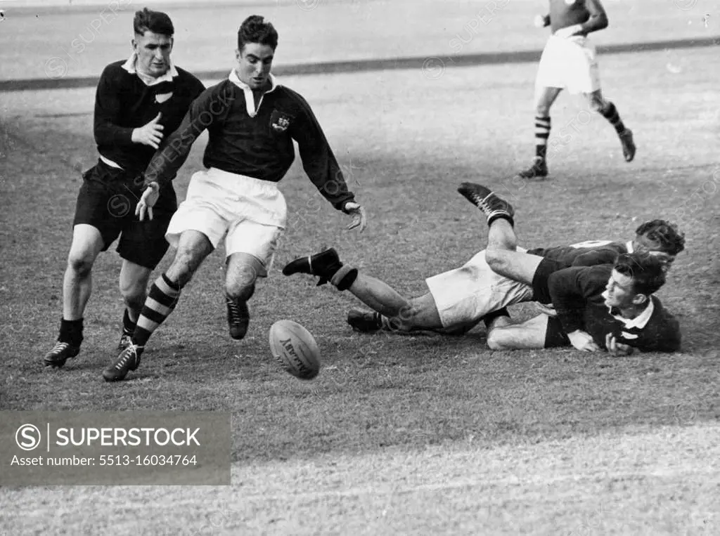 Lines for Rugby Union test pictures: No. 1 Rival centres Alan Walker (Aust White Shorts) (NZ) at left scrimmage for the ball. At inside centre, one favored position, Alan Walker races M. Goddard (NZ). July 01, 1947.