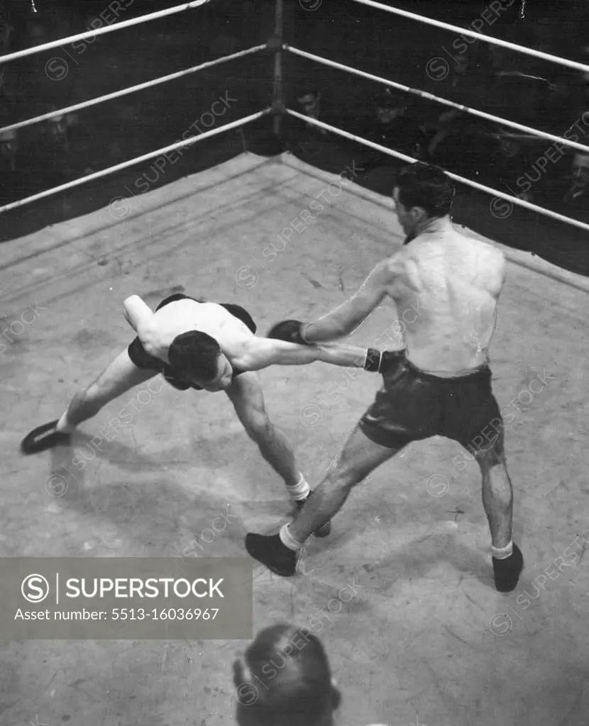 Les Sloane knocks down a long left by Sel Hamilton during their fight at the Stadium last night. July 28, 1946. 