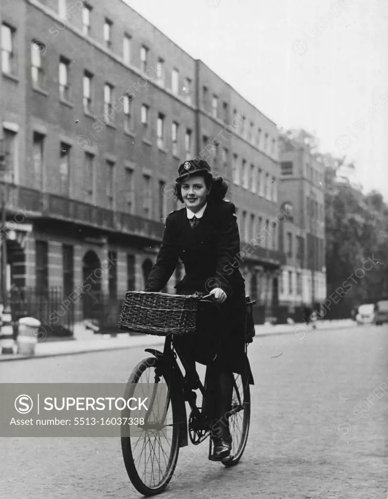 District Nurse Of Bloombsury -- Kathleen cycles off to work again along Bedford Place. Her bags go in a carrier at the back. March 24, 1948. (Photo by Pictorial Press).