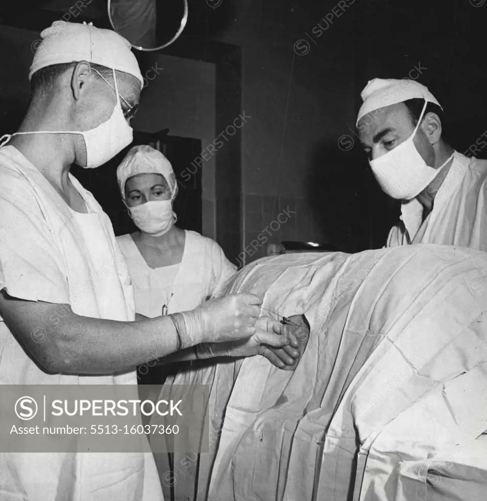 Real pain - killer is a spinal anaesthetic. Above, physician-anaesthetic inserts a hollow needle into the spinal canal as the patient lies a on his side, injecting a regional pain deadener. The patient feels noting. March 22, 1947.