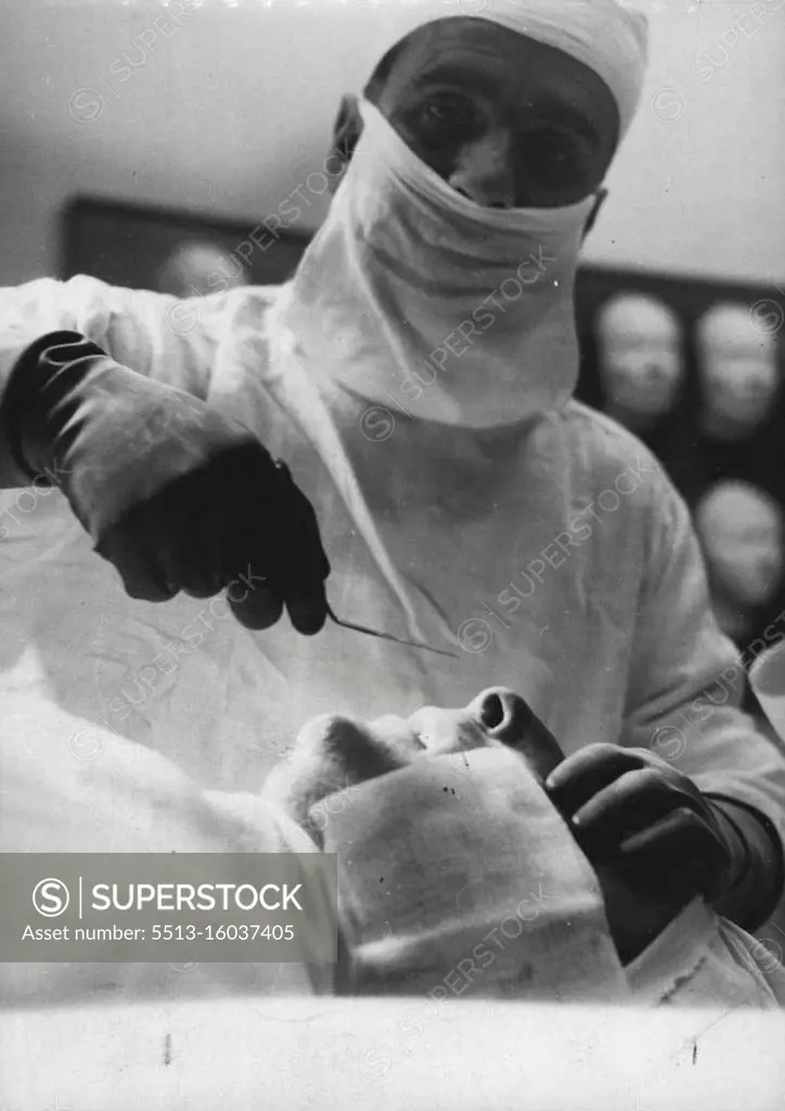 Patient with a nose he thinks is too prominent lies quietly under local anesthetic as Dr. Claque prepares to make an incision near bridge of nose with special. June 06, 1953. 