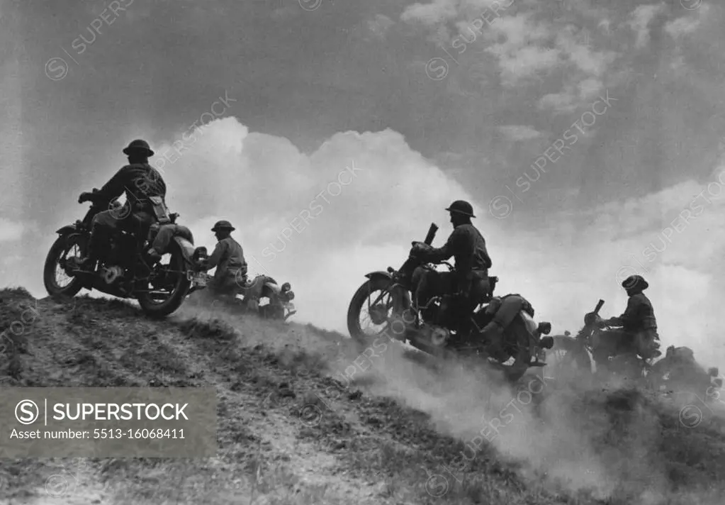 U.S. Soldier Cyclists Go "Over The Top" - Cumulus clouds above, dust clouds below United States motorcycle troops go "over the hump" in maneuvers somewhere in the United States. August 06, 1942. (Photo by Black Star).