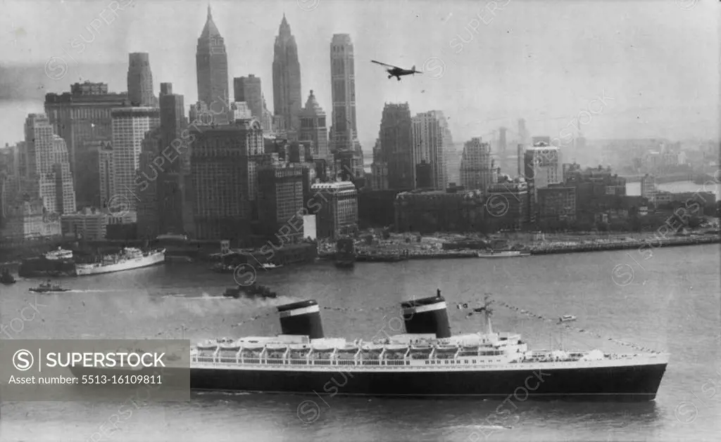 Super Liner Sails On Maiden Voyage -- The United States, America's newest and largest passenger liner, moves past lower Manhattan sailing outbound today on her maiden voyage to Southampton and LeHavre. The new liner carried 1,660 passengers, including Margaret Truman, daughter of the president. July 3, 1952. (Photo by AP Wirephoto).
