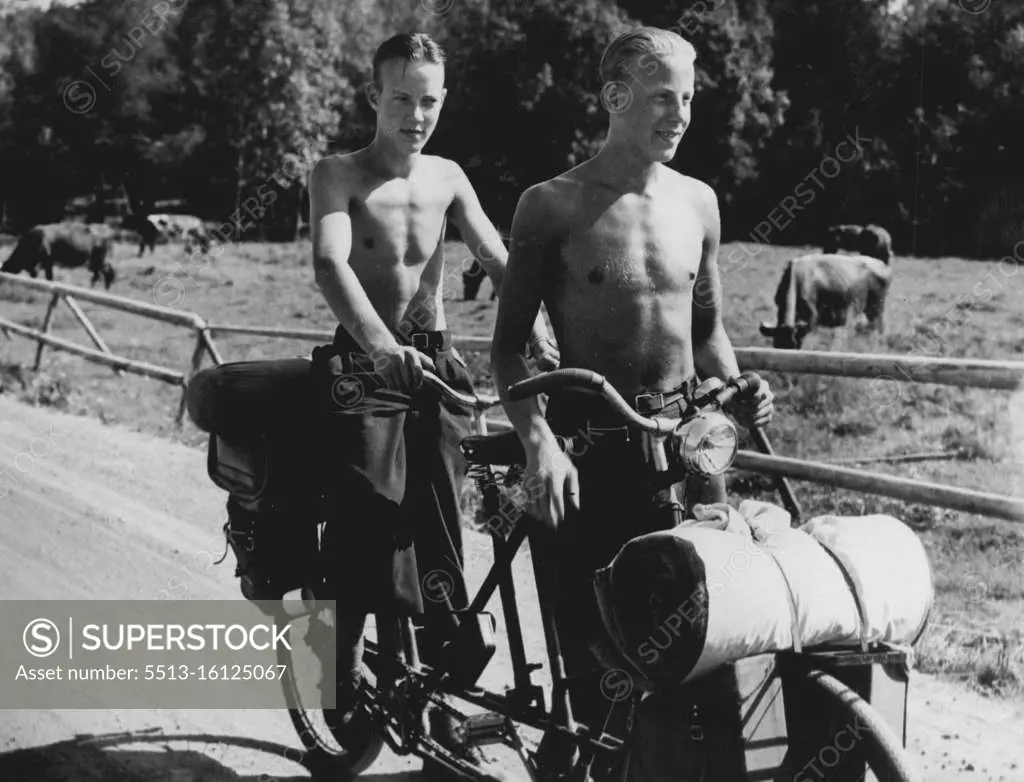 Sweden - Cycling Is Popular In Sweden In The Summer Months: Two boys with a tandem, carrying a light camping outfit. Distance there are not great. A cyclist can cross the country liesurely in less than a week. April 23, 1940. (Photo by Kosmos Press Bureau (Australia) Pty. Ltd.).