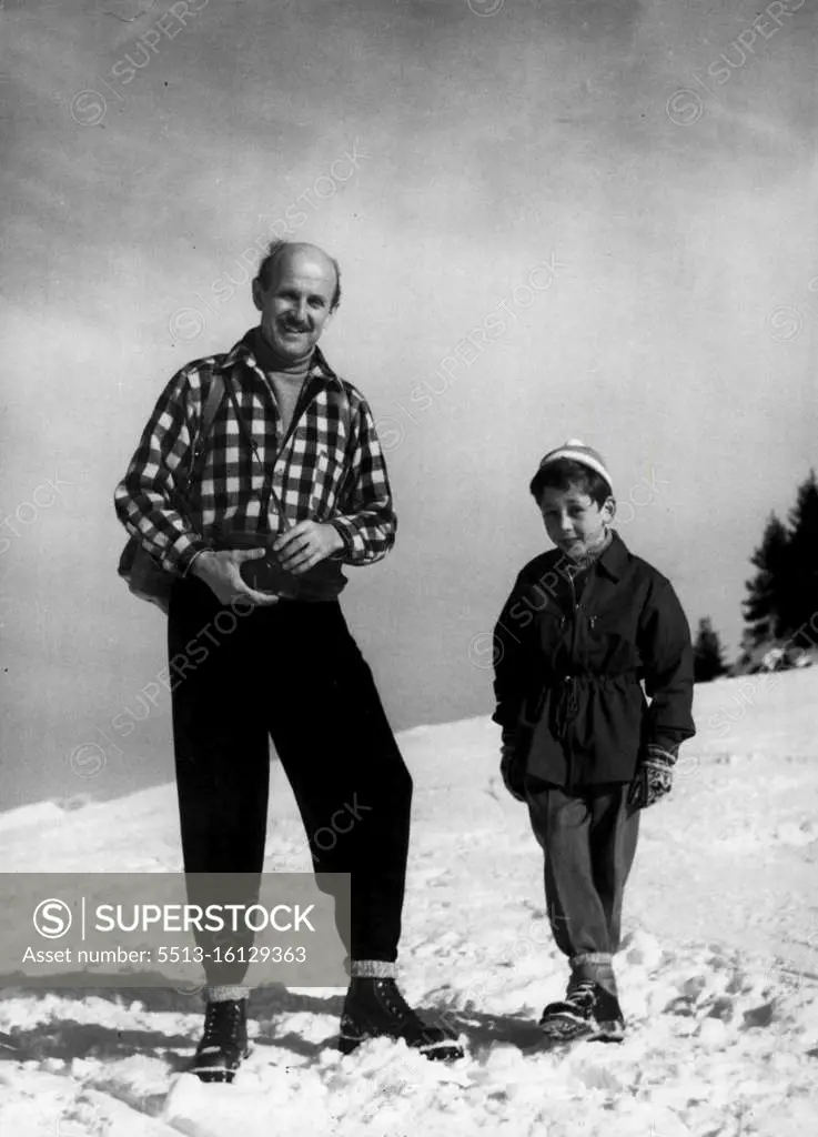 On Winter Sports In Switzerland: Michael Powell, British Film Producer. Photographed on the Wasserngrat heights above Gstaad, with his eight year old son Kevin. March 9, 1954. (Photo by Brodrick Haldane, Camera Press). 
