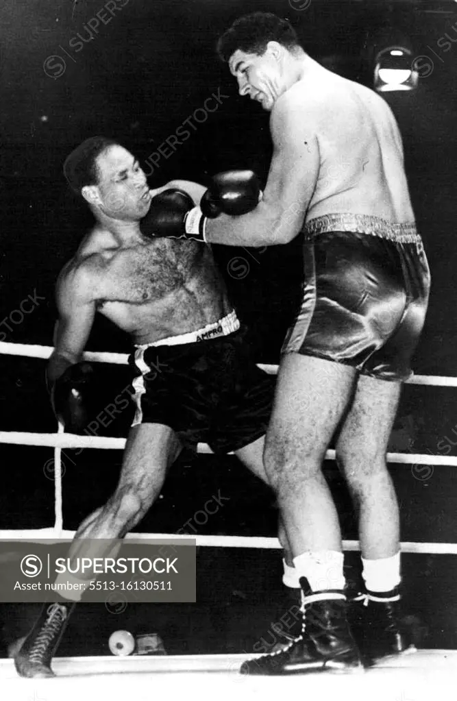 Boxing: Giant South African Wins Again In London Potgieter (right) places a left hand punch hard on the chin of Noel Reid. Ewart Potgieter, the giant South African heavyweight, defeated Noel Reid, of Jamaica in the 3rd round of their contest at the Harringay Arena, London, the referee stopping the fight to save Reid punishment. Potgieter weighed 23 stone 2 lb.; his opponent 15 stone 2lb. October 19, 1955. (Photo by Sports and General Press Agency Limited)