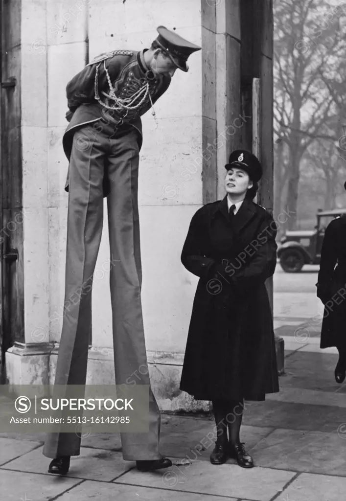 Policewoman Deals With a Tall Boy Henry Lewandowski, stilt-walker in Bertram Mills Circus receives a word of warning from a policewoman about littering Hyde Park with leaflets as the circus parade passed through today. ***** today saw the circus parade, as elephants ***** other attractions of Bertram Mills Circus passed through the streets on their way to Olympia from Victoria Station. December 17, 1951. (Photo by Fox Photos).