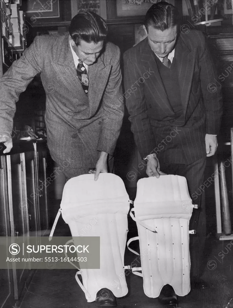 Pads: The new (held by Keith Miller, (left) and the old (held by Ray Lindwall). Note protecting flap on the newer pad. September 26, 1949.
