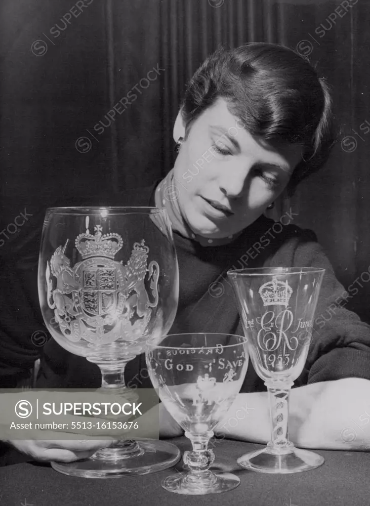 Merit-Who Coronation Souvenirs. Anne Sratton of Highgate Village, London, with three of the souvenirs given merit awards. Left to right: Chalice by Thomas Webb & Corbett, Ltd., Stourbridge, Worcestershire; Crown runner by Stevens & Williams, Ltd., Brierley Hill, Staffordshire; and Commemorative goblet by James Powell & Sons, Ltd. Harrow, Middlesex. Fifty Coronation souvenirs selected by the Coronation Souvenirs Committee from 900 approved designs for special merit awards were shown to-day (Friday) at the Council of Industrial Design Trade Exhibition at Tilbury House, Petty France, London, S.W. January 23, 1953. (Photo by Reuterphoto).