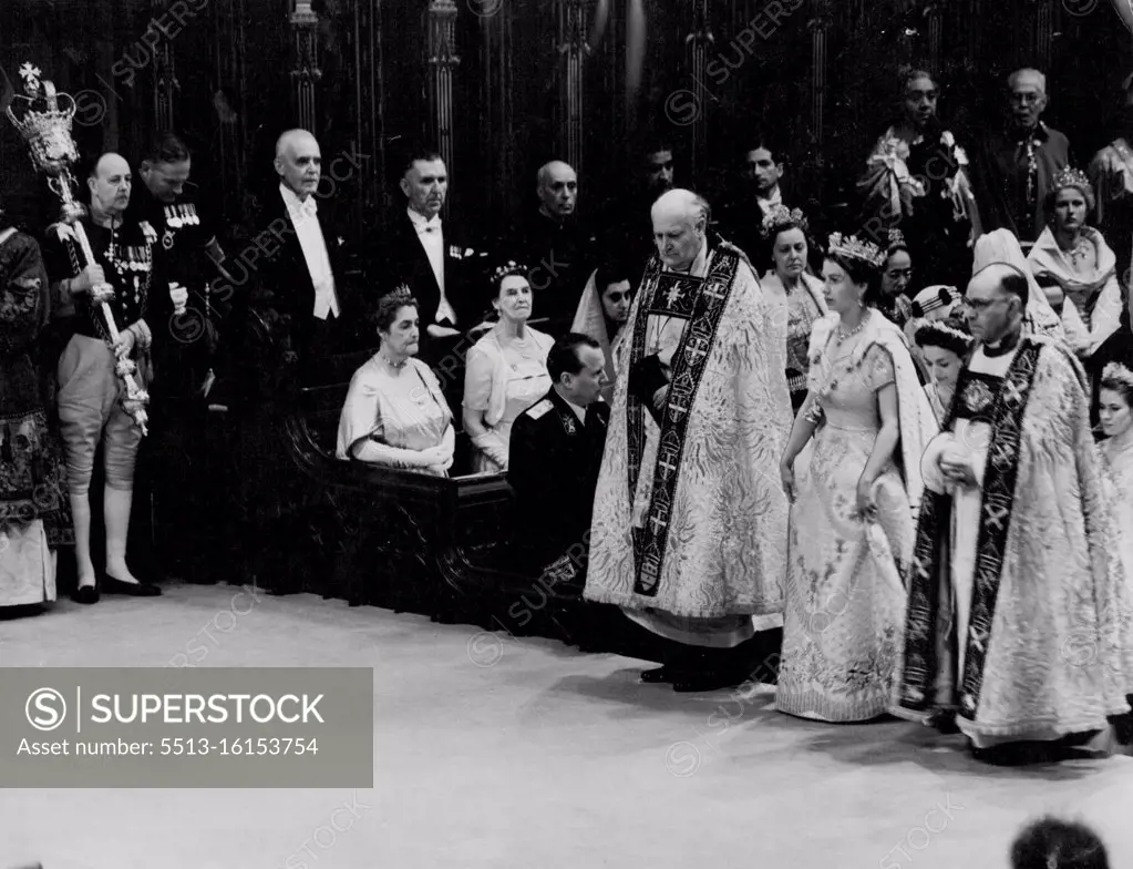 Coronation: The Queen In The Abbey The Queen during her progress through Westminster Abbey after her arrival for the Coronation ceremony to-day (Tuesday). On either side of the Queen are the Bishop of Durham, the Rt. Rev. Arthur Michael Ramsay (left) and the Bishop of Bath and Wells, the Rt. Rev. Harold William Bradfield. The Queen is wearing her Royal robe of crimson velvet, trimmed with ***** and bordered with gold lace. On her head, she has a diadem of precious stones. The Queen is also wearing the collar of the Garter. June 2, 1953. (Photo by Reuterphoto).