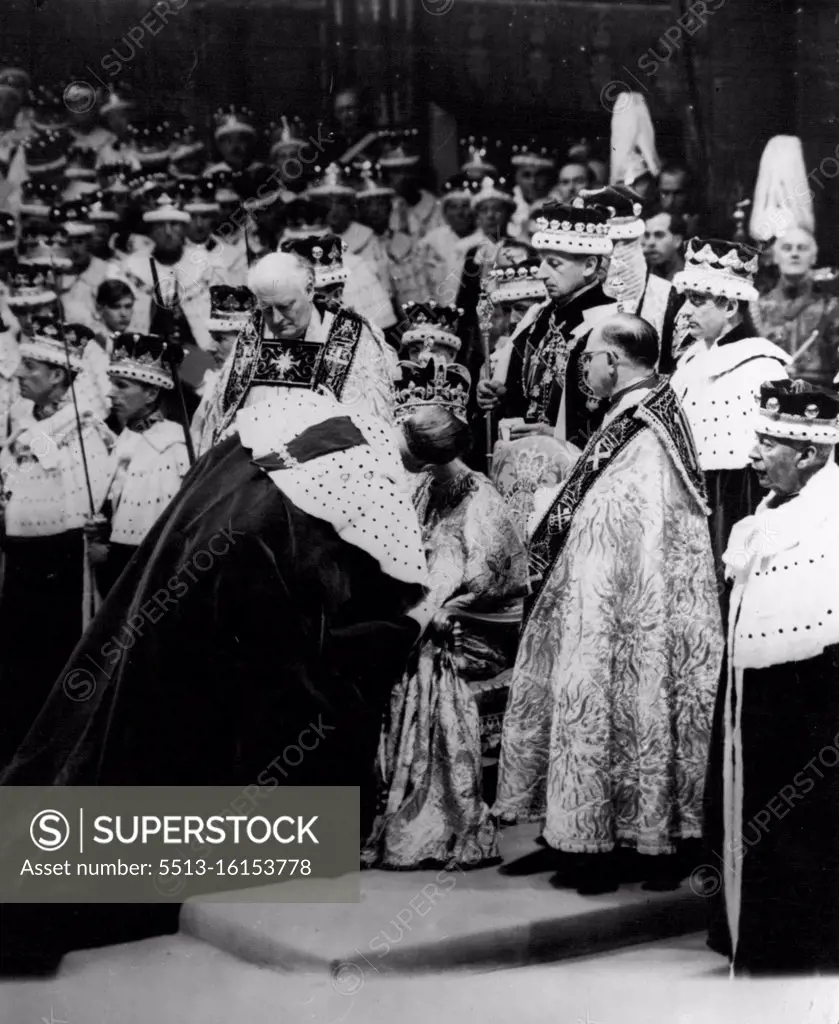 The Queen, wearing St. Edward's Crown and seated on the throne, receives the kiss of homage from her husband, the Duke of Edinburgh, after the crowning ceremony in Westminster Abbey. June 02, 1953. (Photo by Radio Time Hulton Picture Library). 
