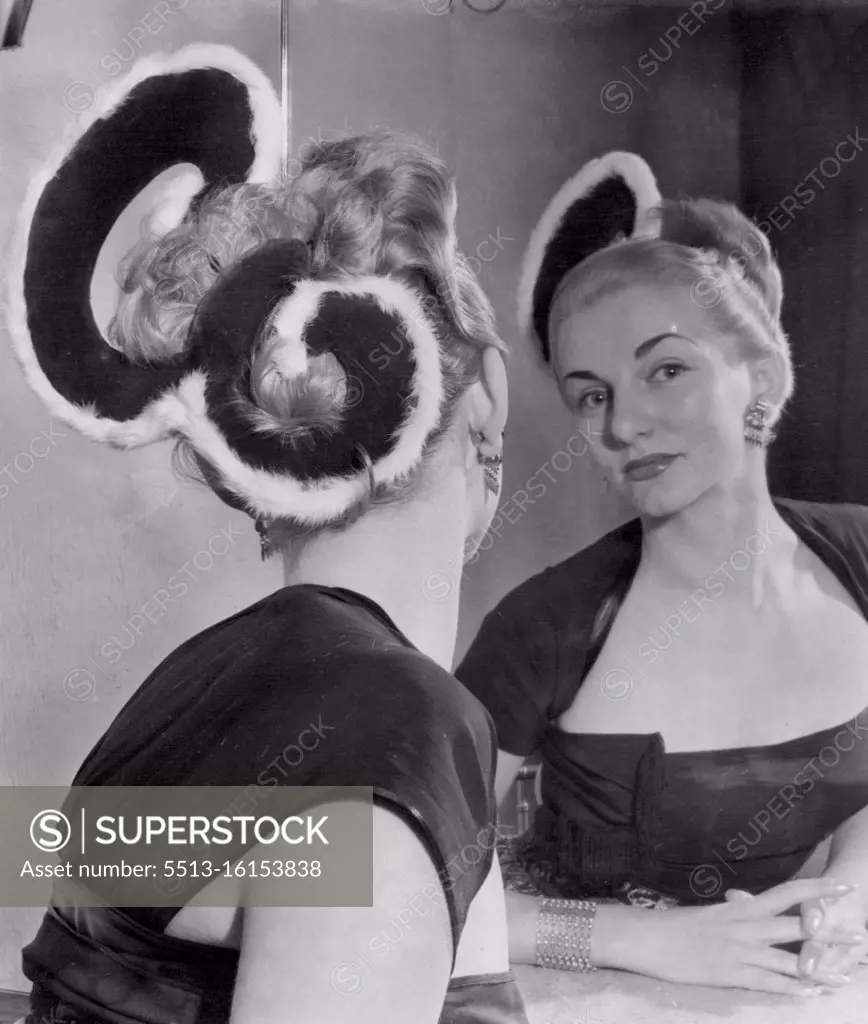 Coronation Goes To Her Head -- Paula Marko this "Royal E" hairstyle with the Queen's cypher carries out in scarlet and ermine. It was one of the variations of his New Elizabethan hairstyle presented by Riche of London of Coronation year. October 29, 1952.