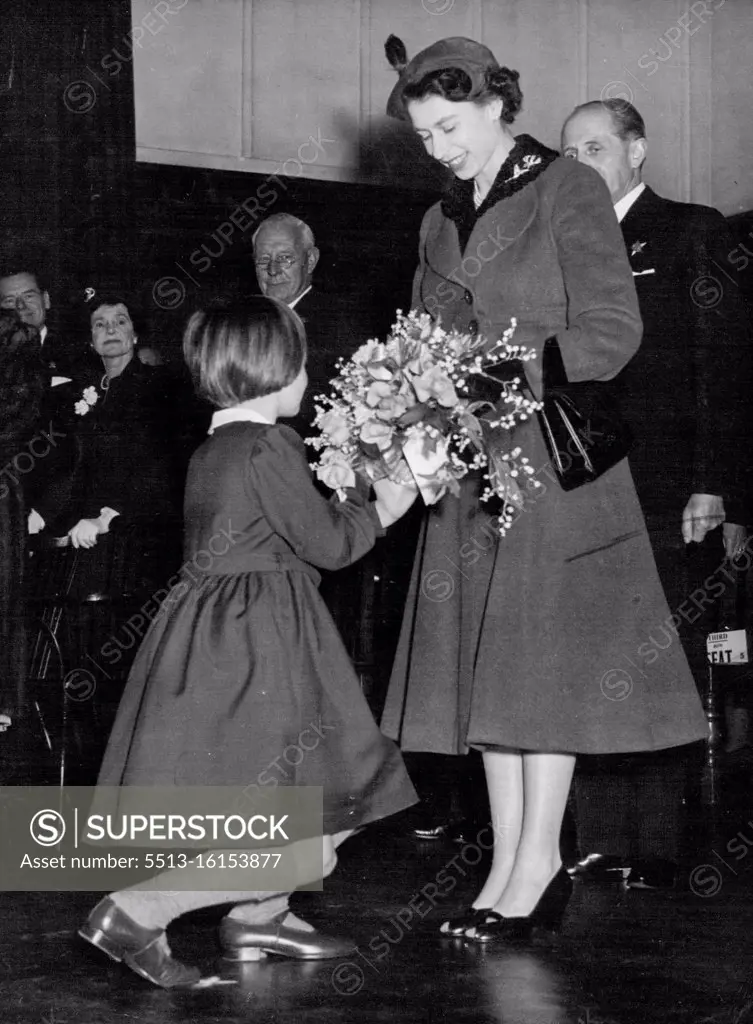 The Queen Visits Girls' School -- Rosemary Kidson, 8, of Leeds, Yorkshire, presents a bouquet to Queen Elizabeth II as Her Majesty arrived at this Royal Masonic School for girls at Rickmansworth, Hertfordshire today March 11. The Queen paid a two-hour visit to the school. There was loud applause when the headmistress, Miss A. Fryer, told the 400 girls that the Queen had asked her if she would allow them an extra day's holiday. March 22, 1955. (Photo by Associated Press Photo).